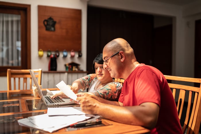 Two adults looking at financial documents. 