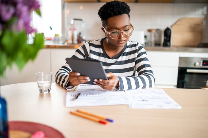 Person holding tablet and looking at cards.